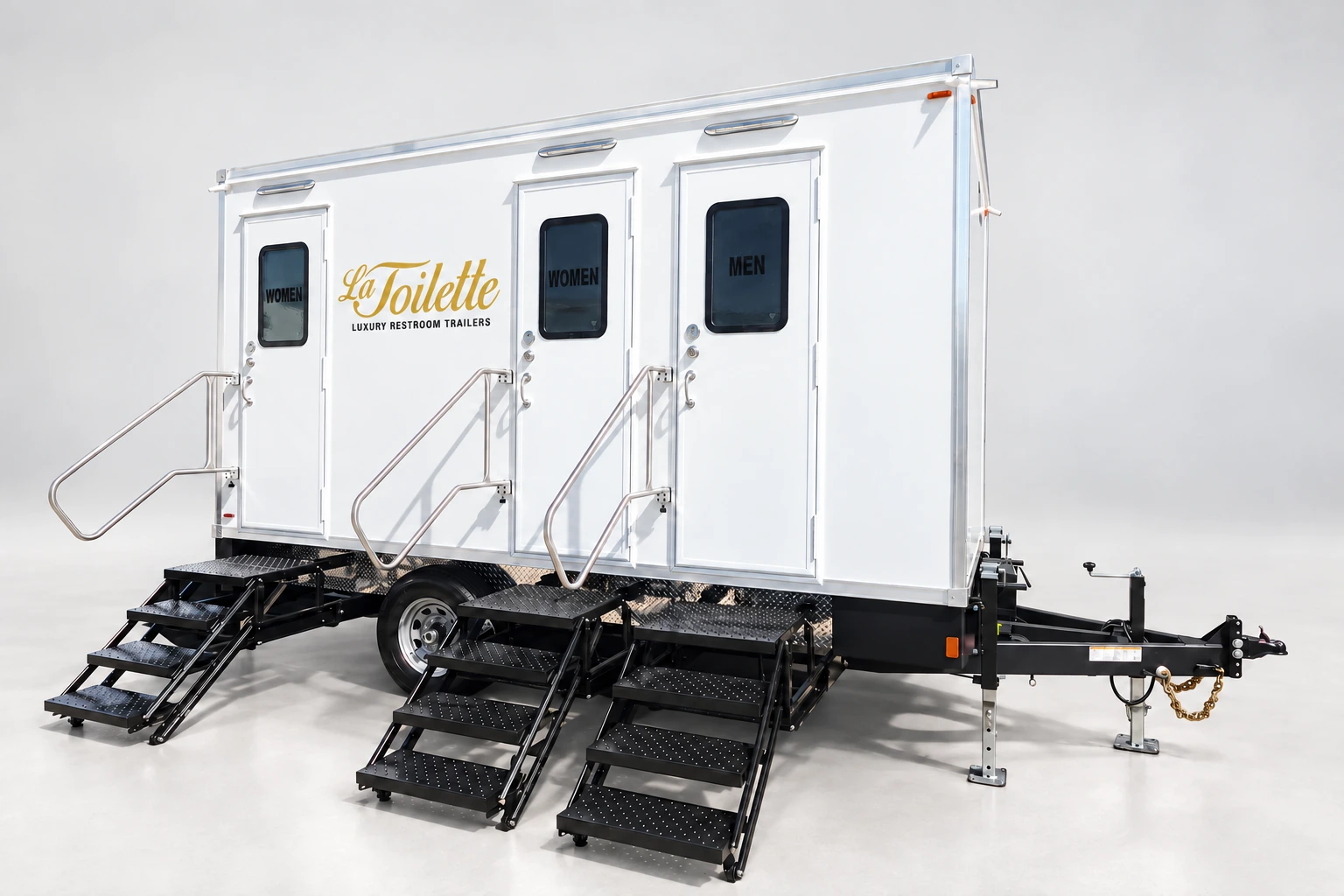 The trailer from its hitch corner, with the three doors and their stairs down